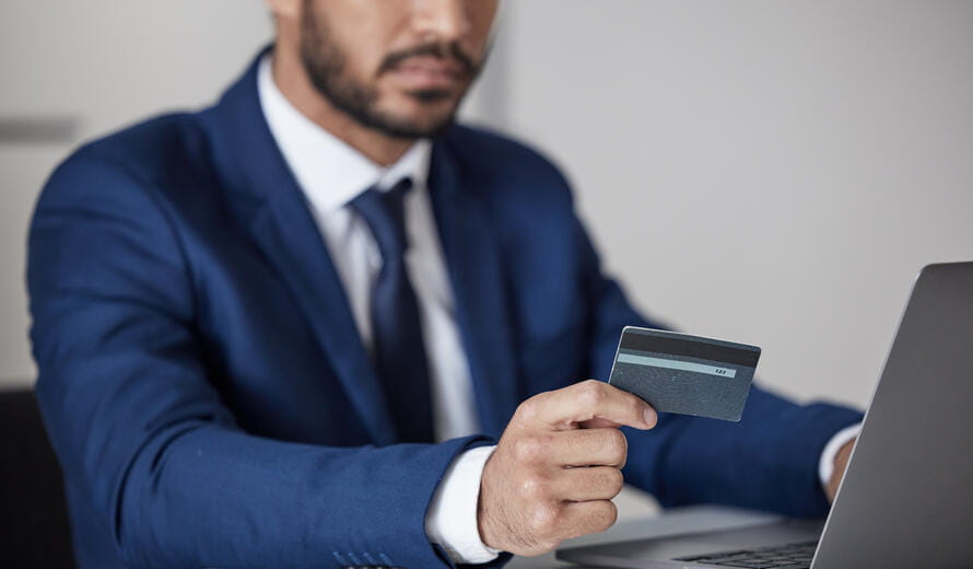 Corporate, man and hands at laptop with credit card for ecommerce, accounting or banking investment. Closeup of trader at computer for online shopping, fintech and trading money in financial economy