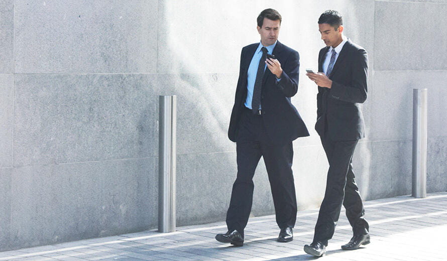 Two men walking in black suit