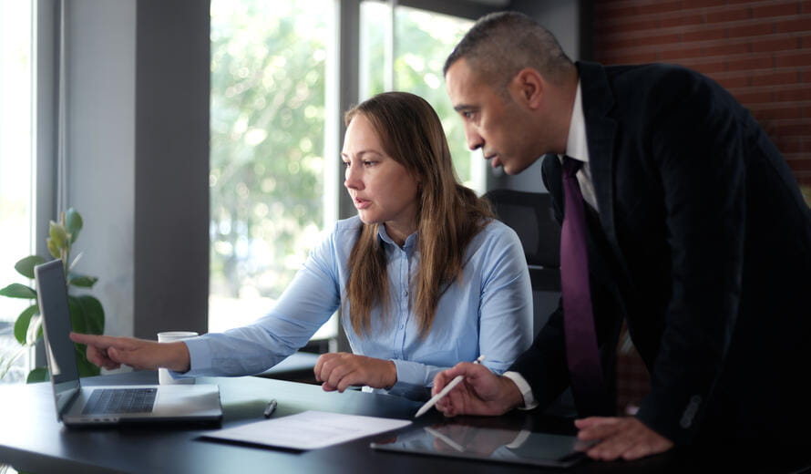 man and woman looking at laptop