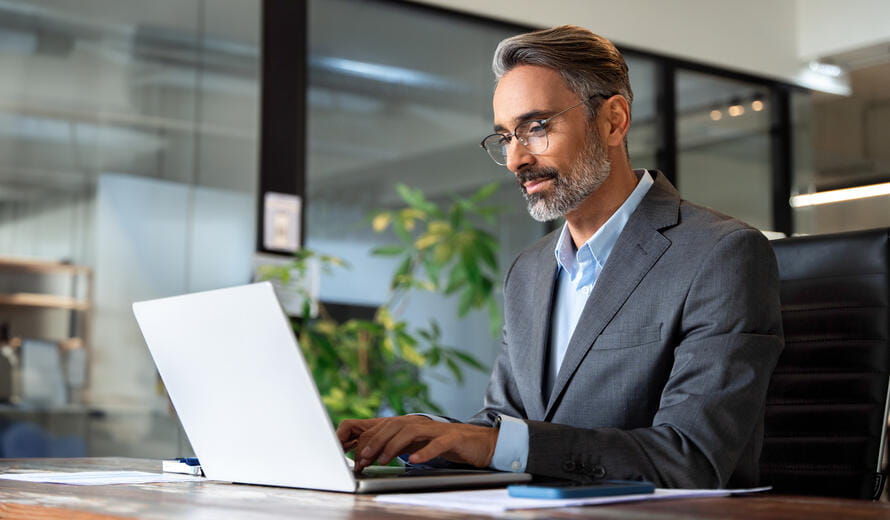 man with glasses on a laptop