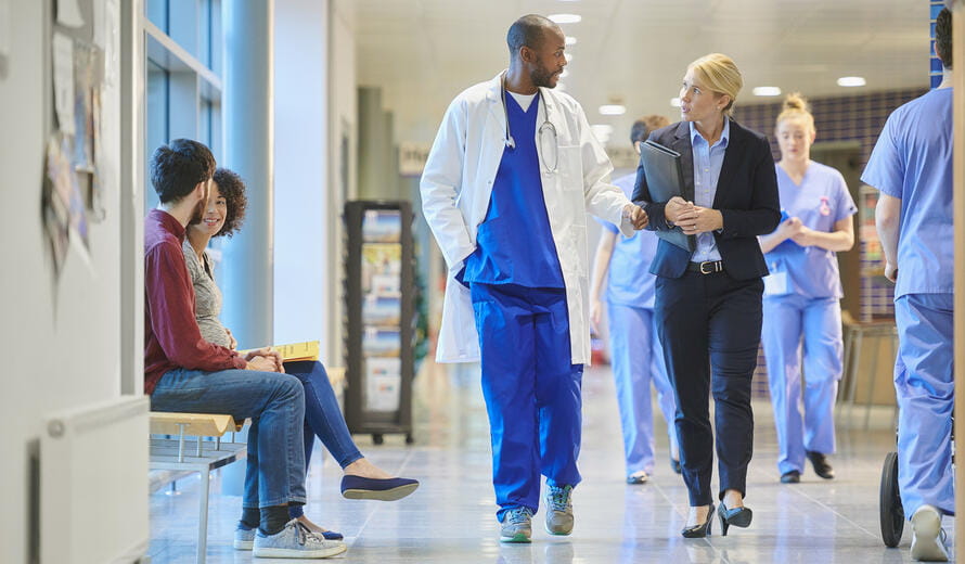 healthcare worker walking with someone